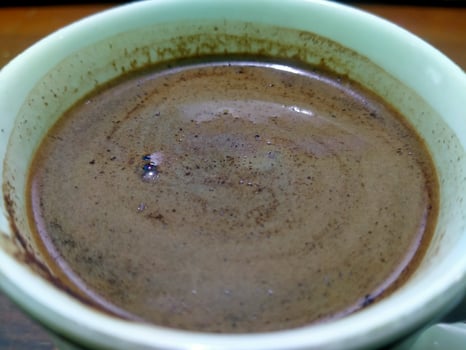 a close up of a cup of coffee with chocolate photo