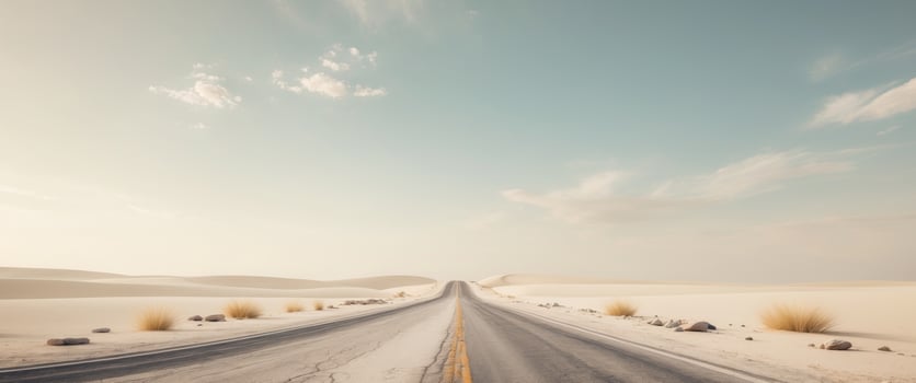 Long desert road leading towards a dramatic horizon photo