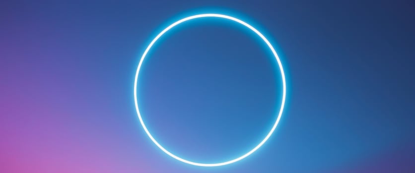 A glowing circle in the sky with a purple and blue background photo