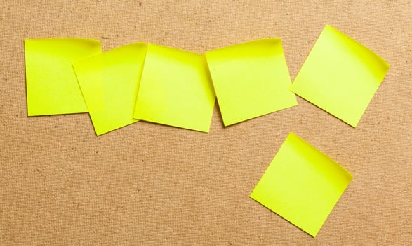Color sticker notes over cork board background photo