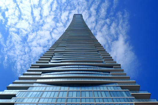 Modern skyscraper towering into the blue sky with clouds in mississauga, ontario photo