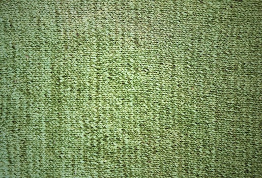 Green woolen texture. A sample of the front knitting. photo