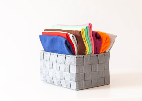 Folded clothes in a box. Home organizing. Vertical storage. photo