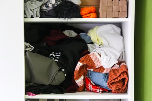 Home wardrobe. Small space organization. The contrast of order and disorder. Vertical storage. photo