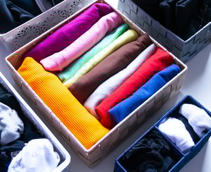 Folded clothes in a box. Home organizing. Domestic vertical storage. photo