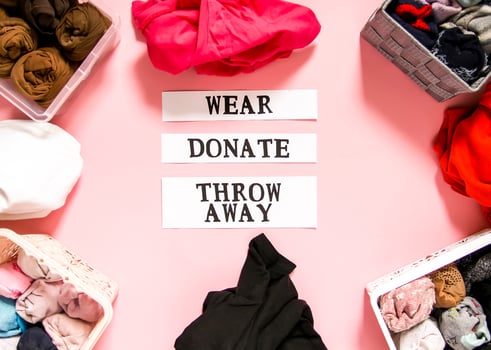 Clothes sorting in home wardrobe for donation, wearing and discard with paper notes photo