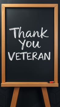 Thank you message written on a chalkboard to honor veterans during a recognition event photo