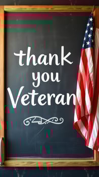 Sign expressing gratitude to veterans displayed beside an American flag in a community setting photo