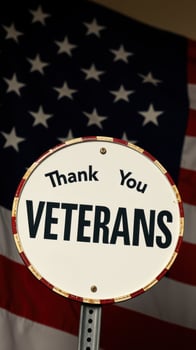 Veterans Day tribute with a sign honoring brave servicemen and women against a backdrop of the American flag photo