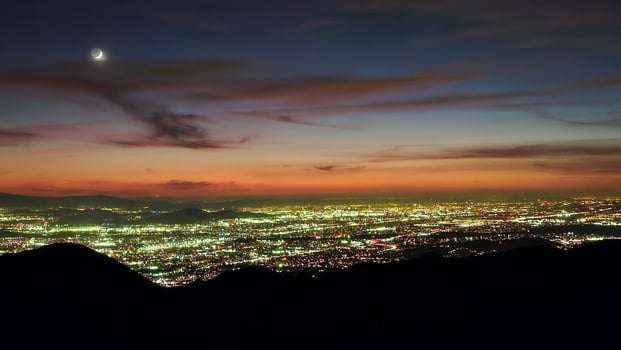 Beautiful Orange Sunset with Moon over the City Lights of San Bernardino photo