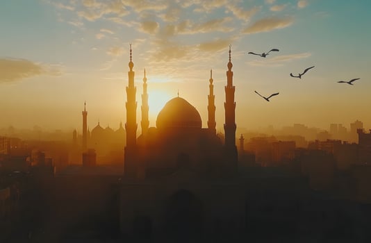 Sunrise Silhouette Of Mosque Over Cityscape photo