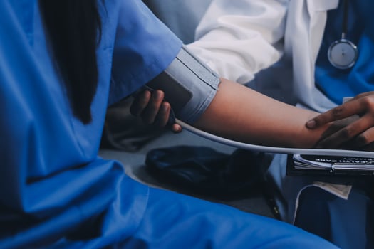 A doctor checking the blood pressure of a patient photo