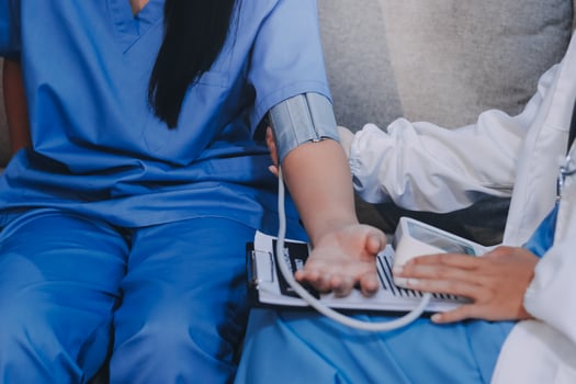 A doctor is checking the blood pressure of a patient photo