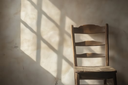 Wooden Chair Against Wall In Sunlight photo