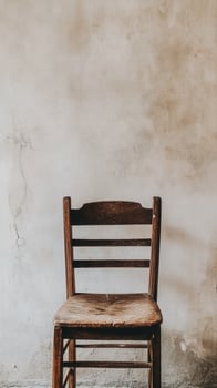 Rustic Wooden Chair Against Weathered Wall photo