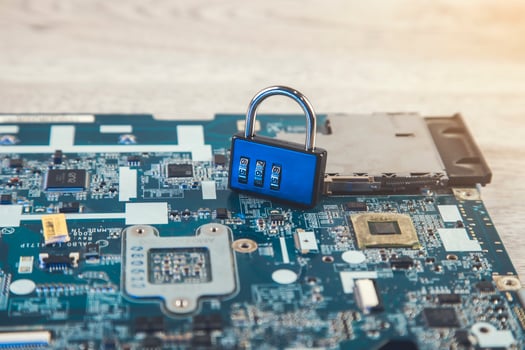 A blue padlock on top of a motherboard photo