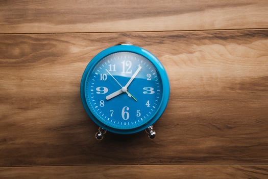 blue clock on the wooden table photo