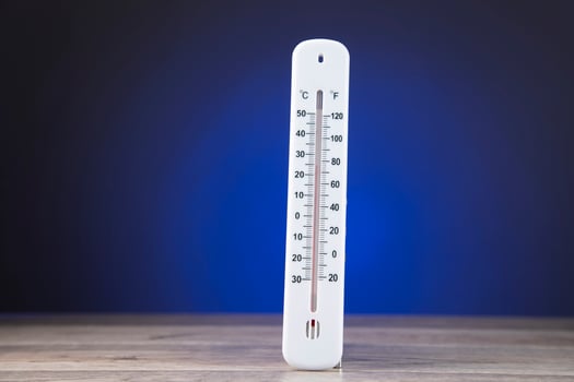 thermometer on blue background photo