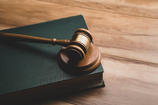 Wooden judge gavel and legal book photo