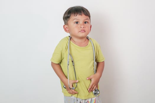 Little kid wearing doctor uniform costume and stethoscope photo
