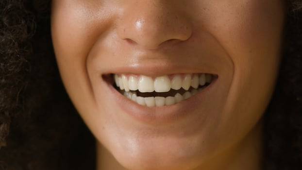 Close up female lips unrecognizable woman beauty face in details white healthy toothy smile dental care happy laughing ethnic African American girl smiling dentistry oral care whitening teeth veneers photo