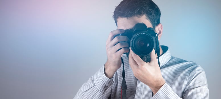 photographer man hand holding camera photo