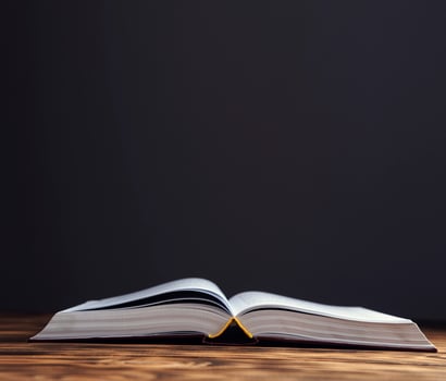 open antique book on wooden photo