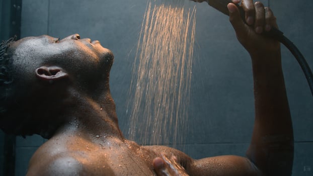 African American man wash wet naked body muscular ethnic guy sexual guy male model washing in shower splashing warm hot water morning hygiene cleaning in bathroom moisture hygienic procedure bodycare photo