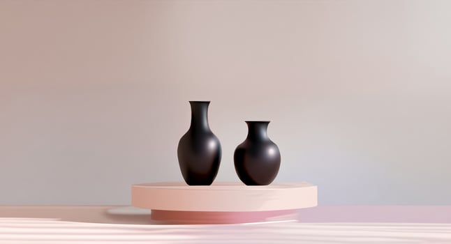 A couple of black vases sitting on top of a pink table photo