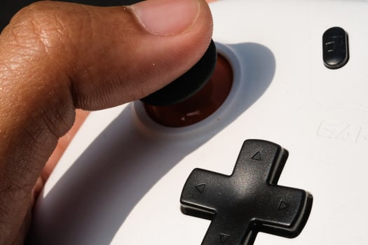 Pressing buttons on a white gamepad. The game controller buttons are set soft and ergonomic. Finger mechanics and Hobbies. Macrophotography Theme photo