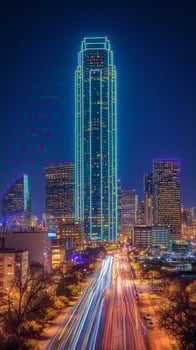 A city skyline at night with lights on the buildings photo