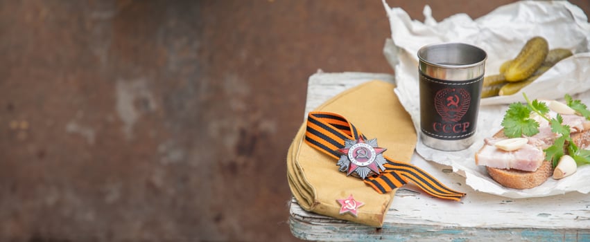 St.George's ribbon and military order,holiday of May 9,Victory Day in the Great Patriotic War,still life on shabby chair with glass of vodka with inscription in Russian USSR,copy space photo