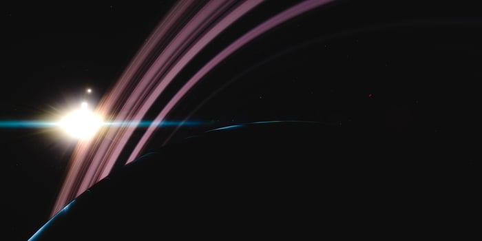Distant sunlight illuminating saturn's rings and moons in deep space scene photo