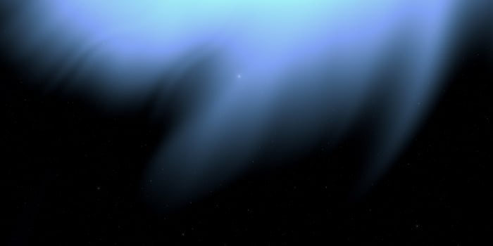 Mysterious blue aurora displaying ethereal glow against starry night sky photo
