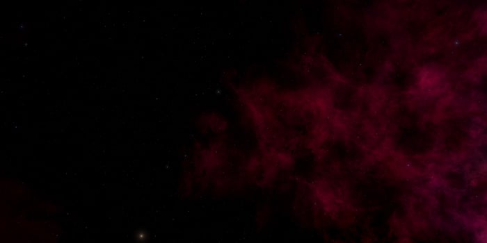 Red nebula against a starry night sky in deep space photo