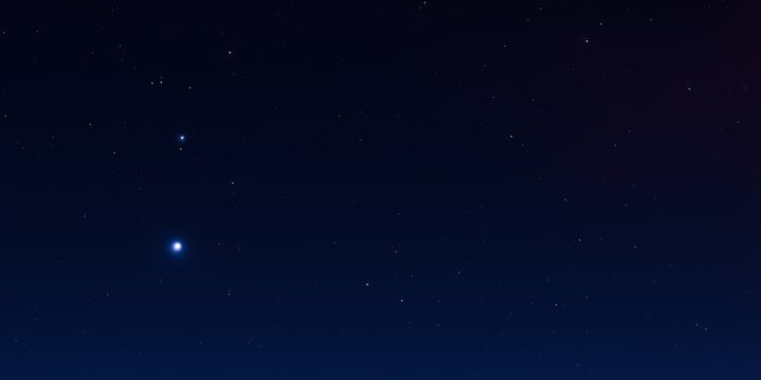 Serene night sky with sparkling stars and deep blue horizon photo