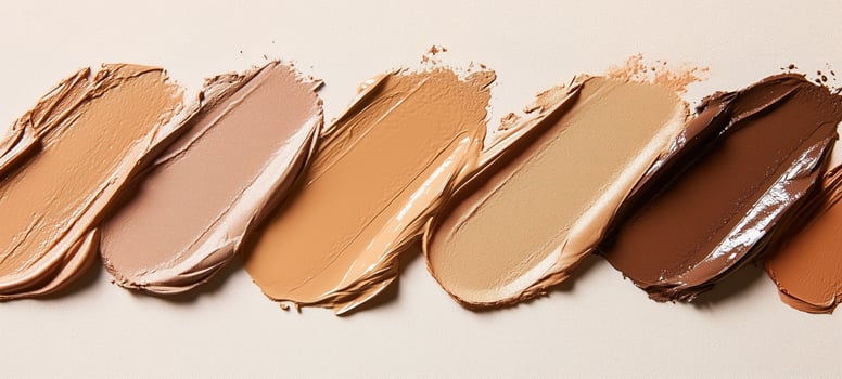 Various shades of foundation smeared. Diversity in skin tones and smooth textures photo