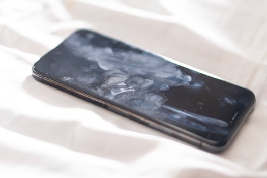 Close-up of a Smudged Smart phone on Soft Surface photo