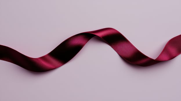 Burgundy ribbon on purple background photo
