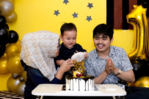 Baby boy with super cute expression. Small family celebrating her first son birthday. photo