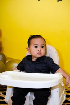 Baby boy with cute expression. Cute baby toddler with confuse face photo