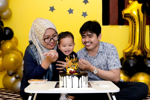Adorable First Birthday Setup with Balloons, Cake, and Smiles. Young family celebrating her baby's first birthday photo