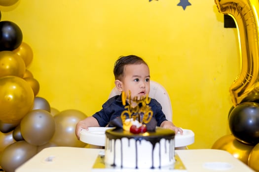 Baby boy celebrating his first birthday. Handsome baby and his birthday cake photo