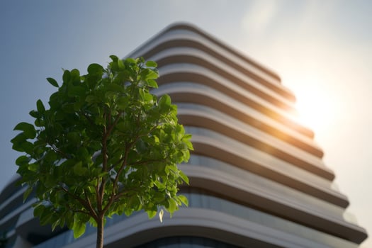 Modern architectural design featuring curved balconies with greenery under sunlight in a vibrant urban environment photo