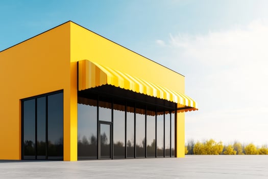 Bright yellow storefront with awning showcasing modern architecture in a sunny outdoor setting photo