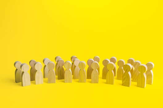 A large group of figurines of people on a yellow background. Social survey and public opinion, electorate. Population and citizens. Human resource, search for candidates. Personnel Management. photo