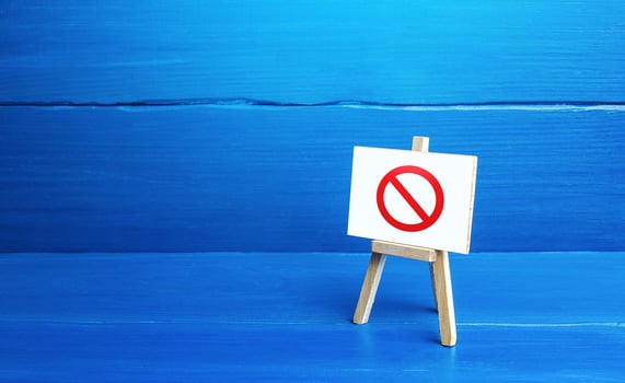 Easel with the prohibition sign NO. Restricted area. Absence. Restrictions and sanctions. Inaccessibility. Ban and Embargo. Failed strategy. Denying entry, stopping action processes. Limitations. photo
