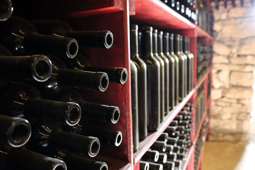 Taste the exquisite selection of wine bottles beautifully stored in a rustic cellar photo