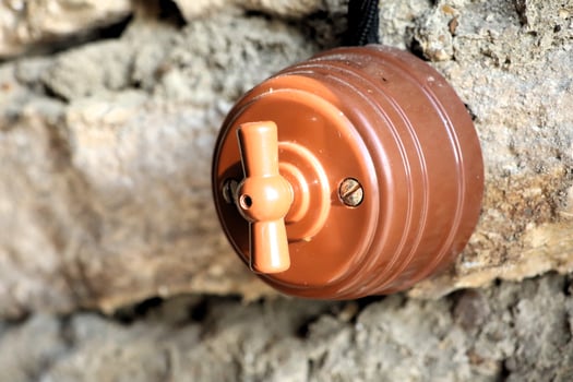 A beautifully designed Vintage Faucet Knob set against a mesmerizing Stone Wall backdrop photo