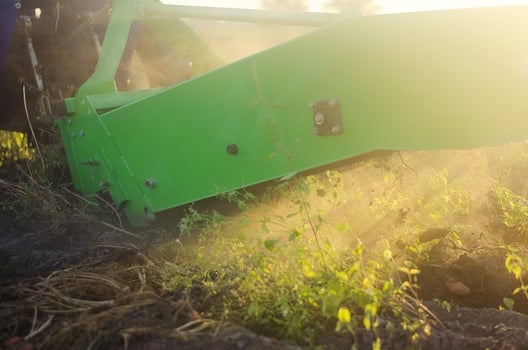 The process of digging potatoes out of the ground. Using machines to improve food production. Farming, agriculture. Countryside farmland. Harvesting campaign with a digging machine. photo